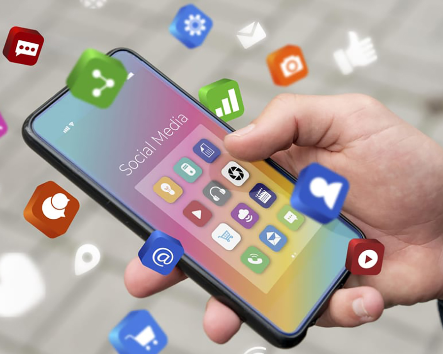 hand holding a cellphone with app icons floating around it